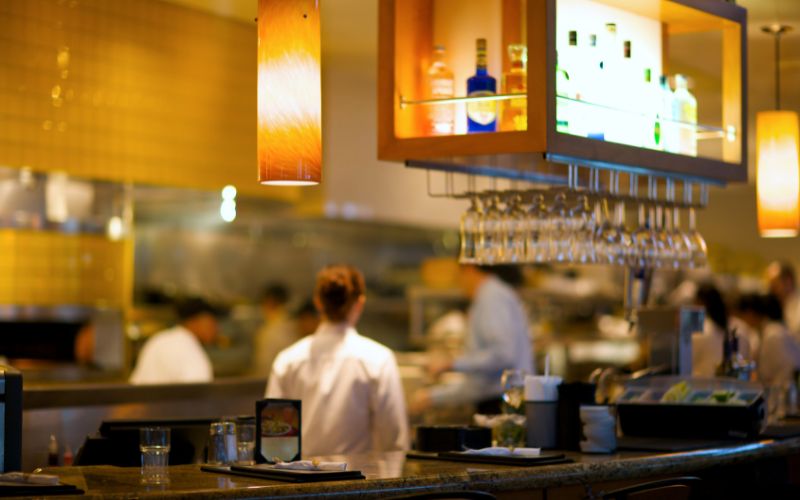 A busy restaurant with customers relaxing and enjoying themselves